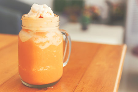 Thai milk tea smoothie in giant glass.