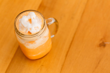 Thai milk tea smoothie in giant glass.