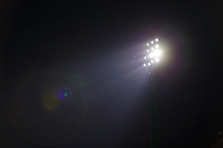 Sport light in football stadium on night time with a lot of little insects.の写真素材