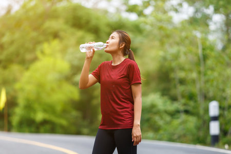 Woman runner's drinking a water after run.の写真素材