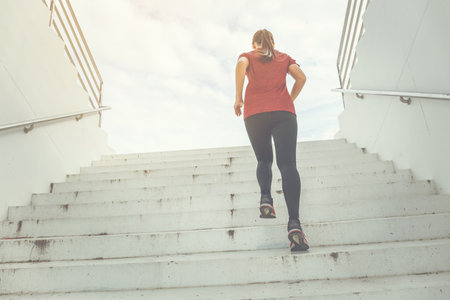 Women's runner using at stadium stair for her running.の写真素材