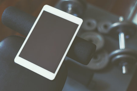 Online weight training coach by tablet, using only dumbbell at home.の写真素材