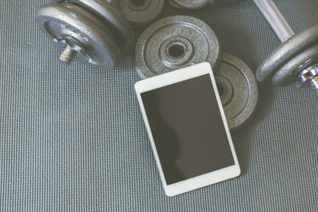 Online weight training coach by tablet, using only dumbbell at home.の写真素材