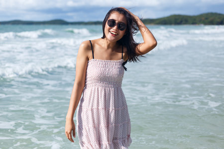 Woman standing and enjoy on the beachの写真素材