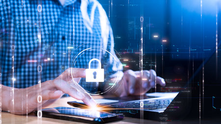 Person using laptop and smartphone with digital key icon symbolizing data security. Binary code and surrounding holographic elements represent online protection and encryption technology.の写真素材
