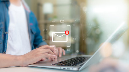Person Checking Email Notifications on a Laptopの写真素材