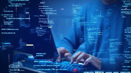 A developer types on a computer with glowing code and binary symbols overlay, symbolizing programming, software development, cybersecurity, and digital technology.の写真素材