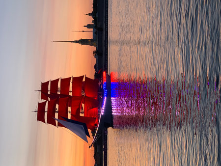 Red sails of a sailing ship against the background of the sunset.