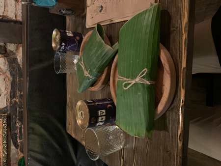 Wooden shelf with old kitchen utensils and green leaves.の写真素材