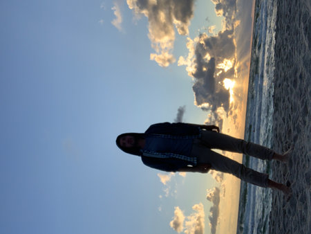 Silhouette of a girl on the background of the sea.の写真素材
