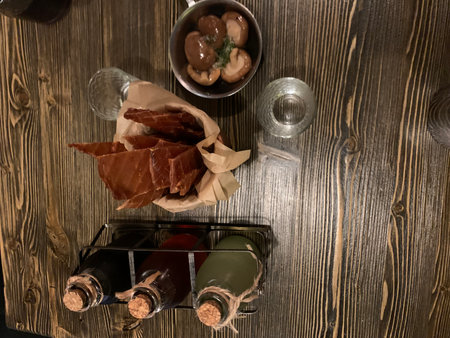 Wine and snacks on a wooden table. Top view with copy space.の写真素材