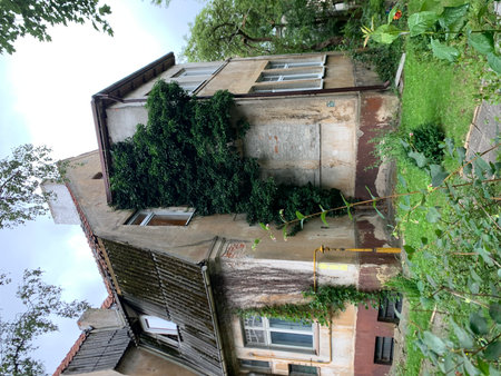 Aerial view of an old house with green plants in the foregroundの写真素材