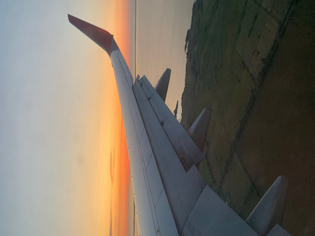 View of the wing of a passenger plane in the sky during flightの写真素材