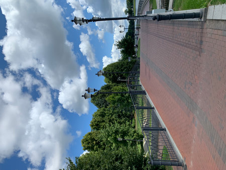 Beautiful blue sky with white clouds over the stairs in the parkの写真素材