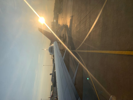 View of the wing of a passenger plane in the rays of the sunの写真素材