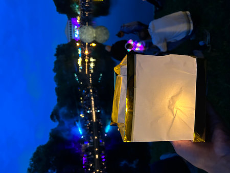 Hand holding a gift box on a background of the night city.の写真素材