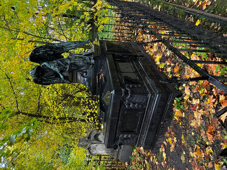 A fragment of the facade of an old building in the autumn park. Monument, cemetery, Novodevichy Cemetery, St. Petersburgの写真素材