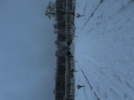 Top view of bridge in winter forest with snow and blue sky.の写真素材
