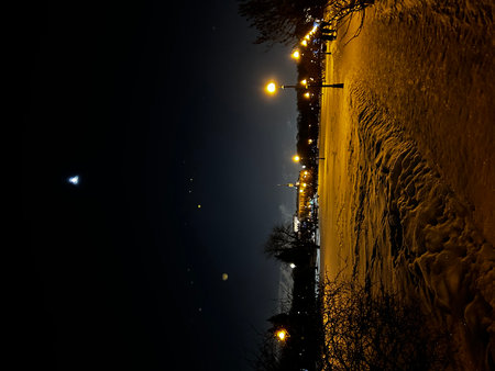 Night view of the bridge over the river on a winter night.の写真素材