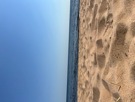 Footprints in the sand on the seashore against the blue sky. Beach, Lake Ladoga, Saint Petersburgの写真素材