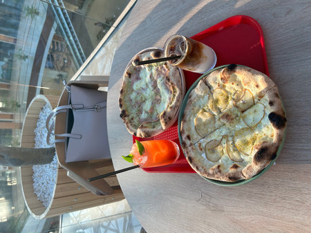 Pizza in a cafe on the table. View from above.の写真素材