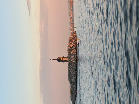 Aerial view of a man standing on the edge of the water.の写真素材