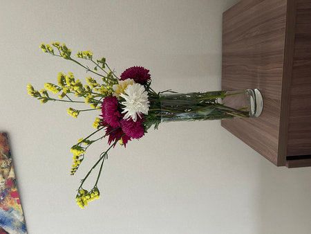 Bouquet of flowers in a glass vase on the kitchen tableの写真素材