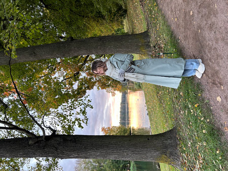 Young woman lying on a tree branch in the park in autumn. Gatchina, St. Petersburgの写真素材