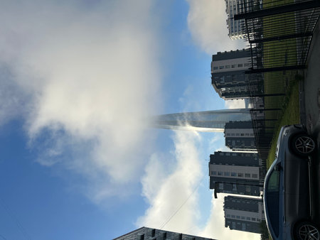 Airplane in the sky with buildings in the background on a sunny day. Lakhta Center, St. Petersburgの写真素材