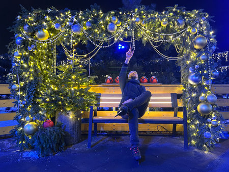 Unidentified people on a park bench at night.の写真素材