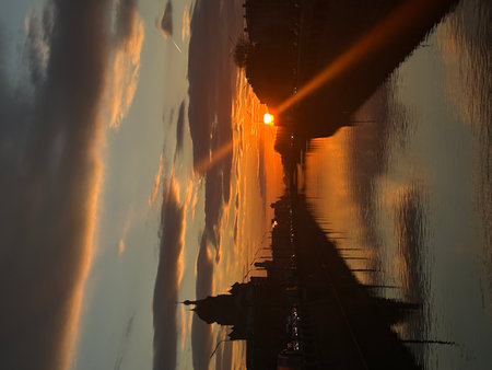 Reflection of sunset in the water of the bridge, Thailand.の写真素材