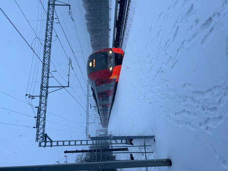high speed train in the snow on a winter day, closeup of photoの写真素材