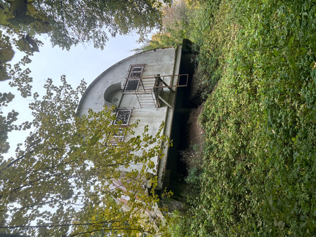 Abandoned water tower in the middle of the forest in autumnの写真素材