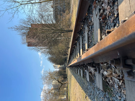 Railway tracks against the blue sky and the reflection of trees.の写真素材