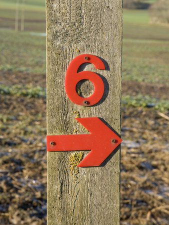 Red number 6 and red arrow on a postの写真素材