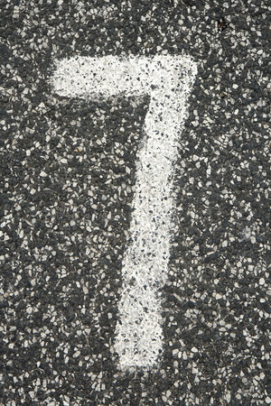 Number 7 written on asphalt in a parking space. Can be used as backgroundの写真素材