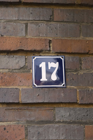 House number 17 on a brown brick wallの写真素材