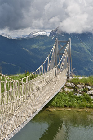 Small bridge crossing a lake in the mountains near Salzburg, Austriaの写真素材