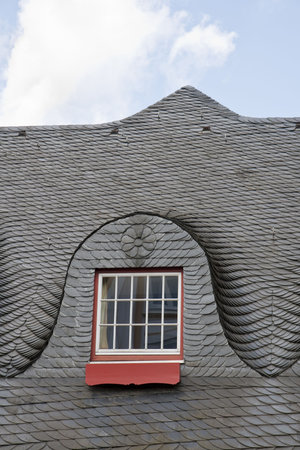 Slated roof with red and white window. Shot from Timmerdorfer Strand, Germanyの写真素材