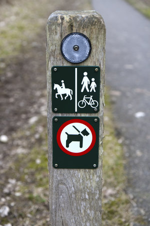 Signs on a pole at a Danish hiking path