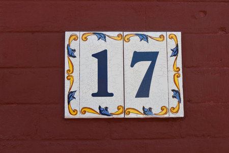 House number 17 on a red wooden wallの写真素材