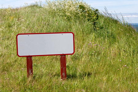 Blank red and white sign on a hillの写真素材