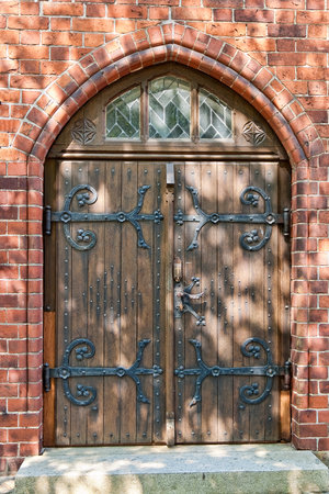 Double church door with shadows from nearby treesの写真素材