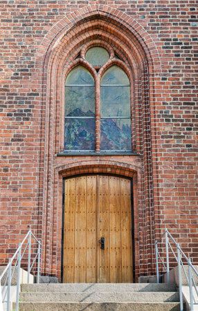 Closeup on a church door and window. Shot from "Vor Frue Church" in Svendborg, Denmarkの写真素材