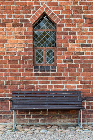 Bench underneath a leaded church window. Closeupの写真素材