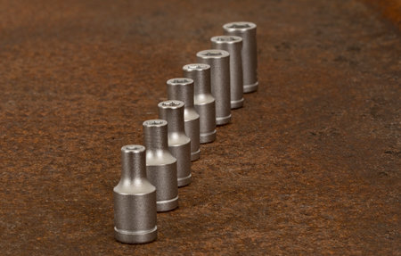 Closeup on socket wrench parts placed on at rusty steel plate