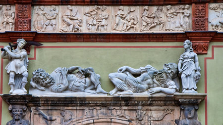 Old sculptures on a wall on a public building in Germanyの写真素材