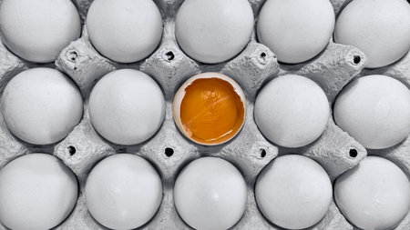 Closeup on a tray of eggs, partly black and white