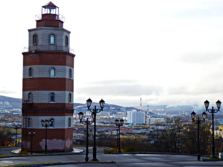 Triped colored lighthouse. Marine, sea and oceanic object. Building for studying the surroundings and coastal areas, lighting the way for ships.の写真素材