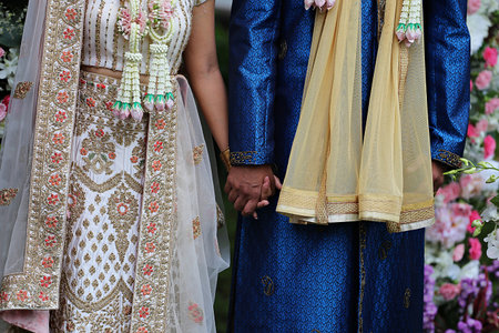 couple holding hands in wedding ceremonyの写真素材